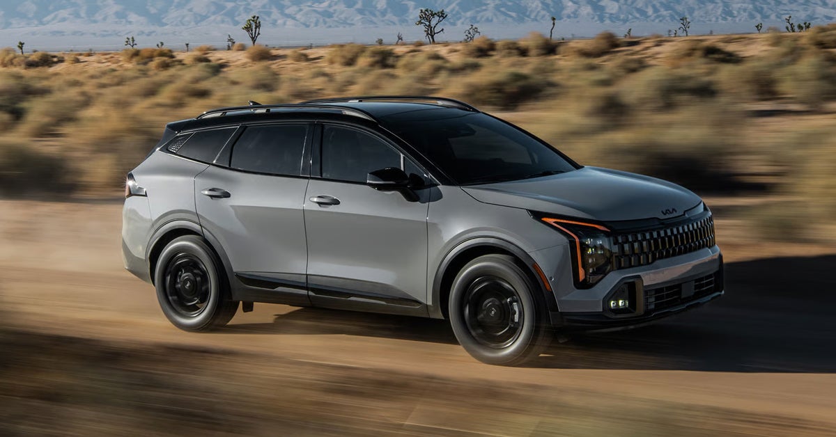 2027 Kia Sportage - Driving along a dusty desert road